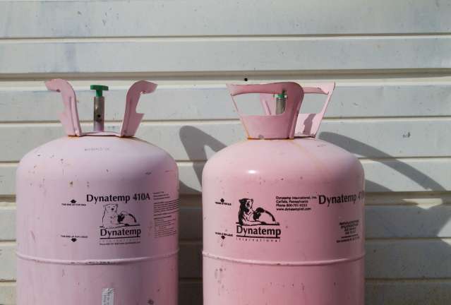 two pink Dynatemp 410 tanks on front of white wall